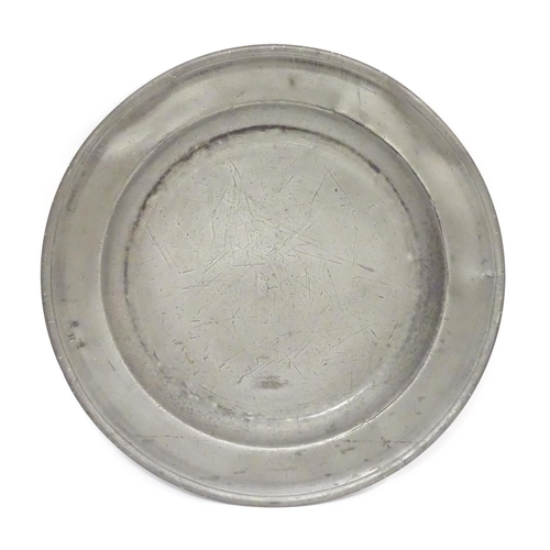 1131 - A pewter plate / charger  stamped to rim IHA, and  stamped with touch marks under. 15