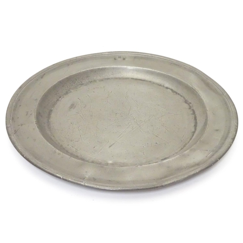 1131 - A pewter plate / charger  stamped to rim IHA, and  stamped with touch marks under. 15