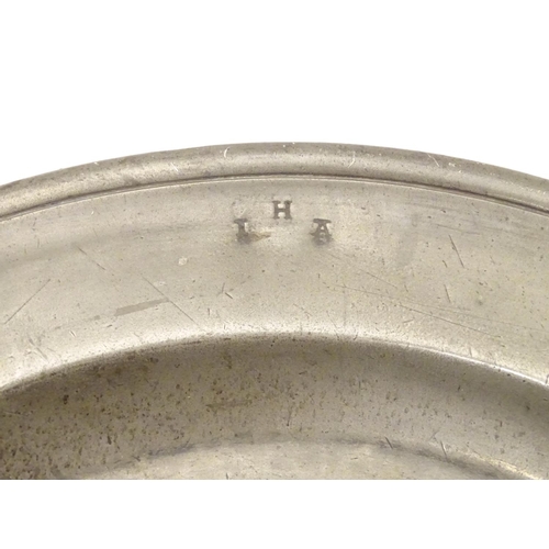 1131 - A pewter plate / charger  stamped to rim IHA, and  stamped with touch marks under. 15