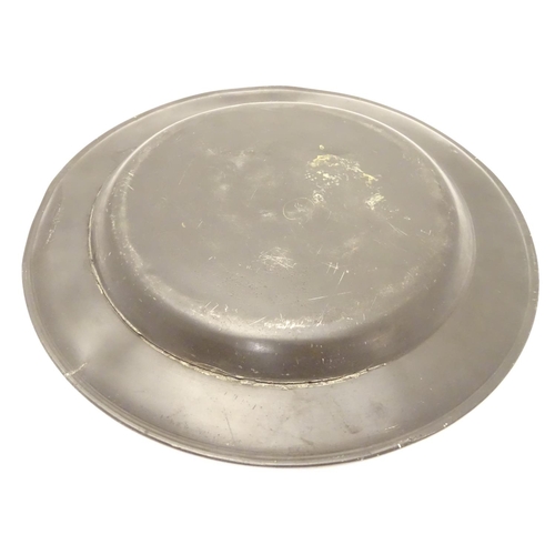 1131 - A pewter plate / charger  stamped to rim IHA, and  stamped with touch marks under. 15