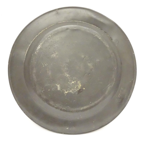 1131 - A pewter plate / charger  stamped to rim IHA, and  stamped with touch marks under. 15