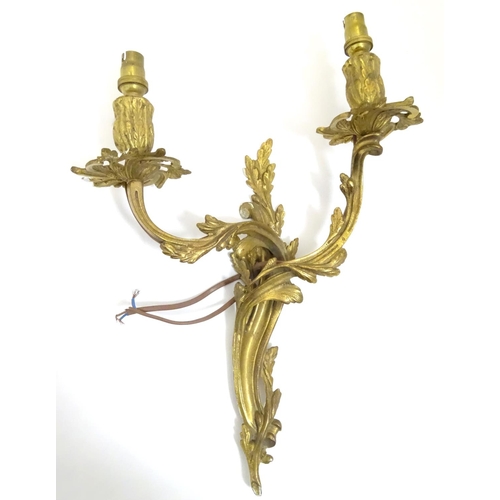 1203 - Two gilt wall light sconces , one a Louis XV Style Wall Light Sconce with acanthus scroll detail, th... 