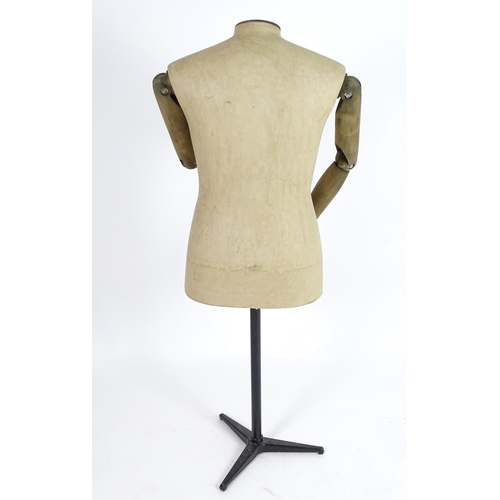 780 - A Stockman Paris mannequin, with turned hardwood articulated limbs and cast iron tripod stand, 52