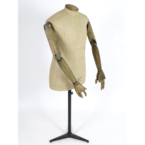 780 - A Stockman Paris mannequin, with turned hardwood articulated limbs and cast iron tripod stand, 52