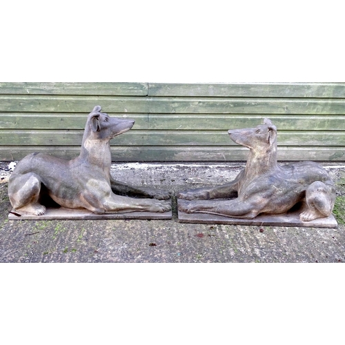 782 - Garden & Architectural, Salvage: a pair of stone garden ornaments formed as couchant hounds / dogs u... 