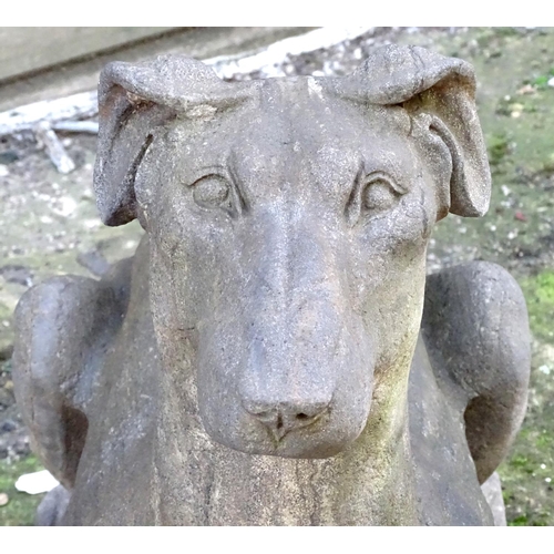 782 - Garden & Architectural, Salvage: a pair of stone garden ornaments formed as couchant hounds / dogs u... 