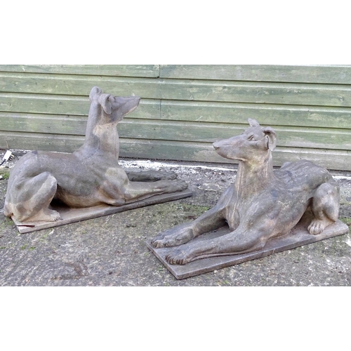 782 - Garden & Architectural, Salvage: a pair of stone garden ornaments formed as couchant hounds / dogs u... 