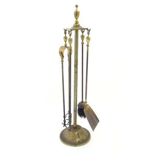 790 - Garden & Architectural, Salvage: an early to mid 20thC brass fireside companion set, comprising brus... 