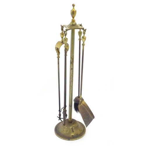 790 - Garden & Architectural, Salvage: an early to mid 20thC brass fireside companion set, comprising brus... 