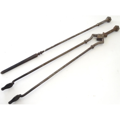 791 - A pair of 19thC Gothic Revival wrought iron fire tools, comprising tongs and poker, each having octa... 