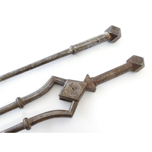 791 - A pair of 19thC Gothic Revival wrought iron fire tools, comprising tongs and poker, each having octa... 