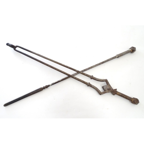 791 - A pair of 19thC Gothic Revival wrought iron fire tools, comprising tongs and poker, each having octa... 