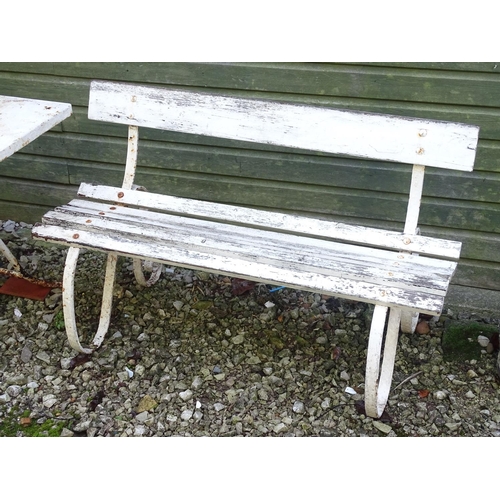 796 - A Victorian garden bench with wrought iron mounts and wooden slatted seat, white painted finish, tog... 