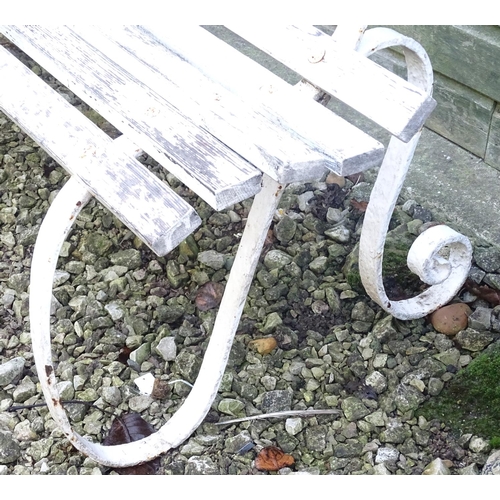 796 - A Victorian garden bench with wrought iron mounts and wooden slatted seat, white painted finish, tog... 