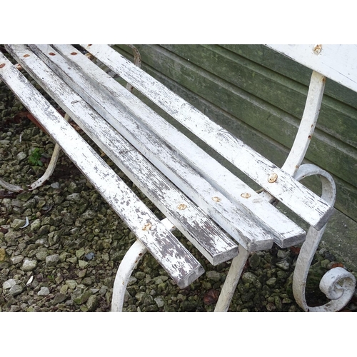 796 - A Victorian garden bench with wrought iron mounts and wooden slatted seat, white painted finish, tog... 