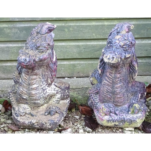 797 - Garden & Architectural, Salvage: a pair of mid 20thC cast stone pillar ornaments formed as dragon he... 