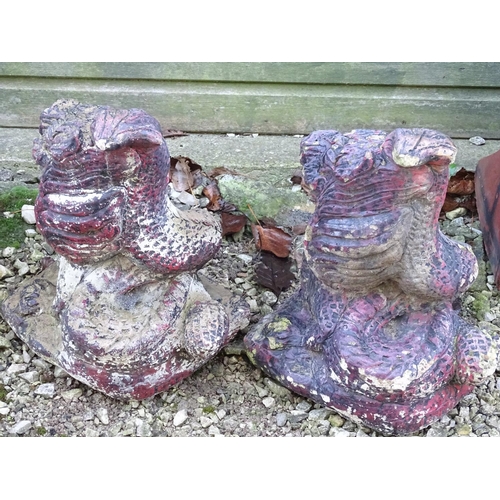 797 - Garden & Architectural, Salvage: a pair of mid 20thC cast stone pillar ornaments formed as dragon he... 