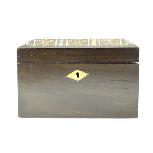 1010 - A Victorian tea caddy with a decorative border and motif with painted detail and inlaid abalone, bon... 