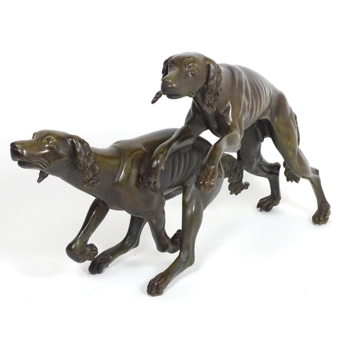 1011 - A 20thC large bronze sculpture modelled as two dogs / hounds running. Approx. 25