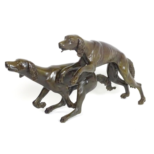 1011 - A 20thC large bronze sculpture modelled as two dogs / hounds running. Approx. 25