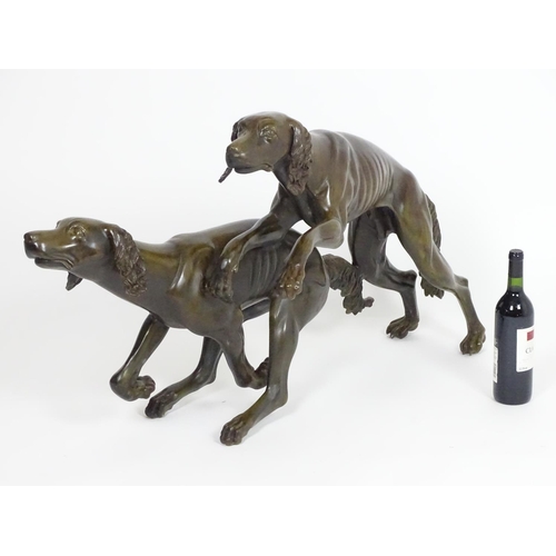 1011 - A 20thC large bronze sculpture modelled as two dogs / hounds running. Approx. 25