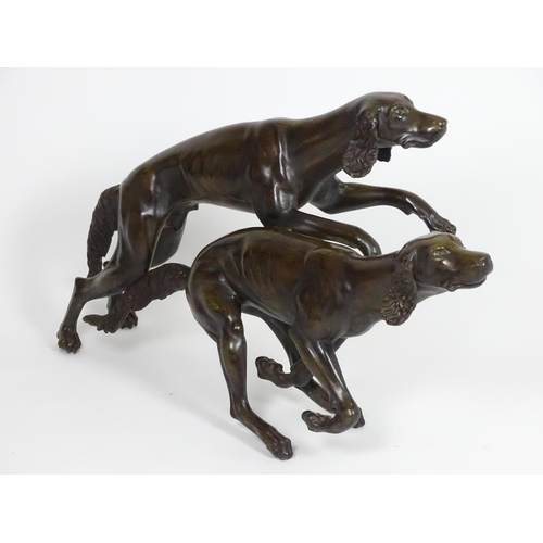 1011 - A 20thC large bronze sculpture modelled as two dogs / hounds running. Approx. 25