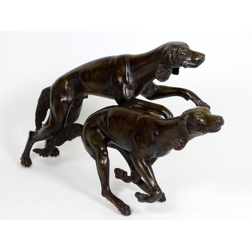 1011 - A 20thC large bronze sculpture modelled as two dogs / hounds running. Approx. 25