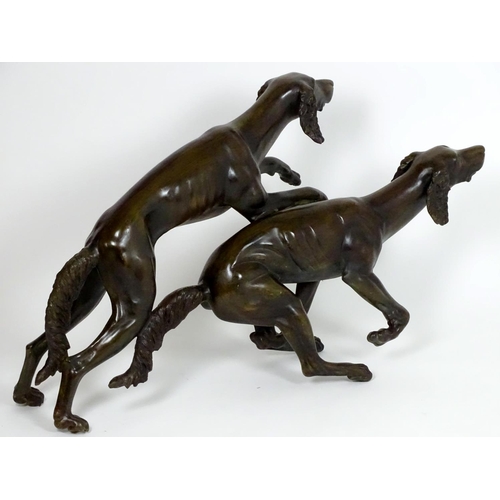 1011 - A 20thC large bronze sculpture modelled as two dogs / hounds running. Approx. 25