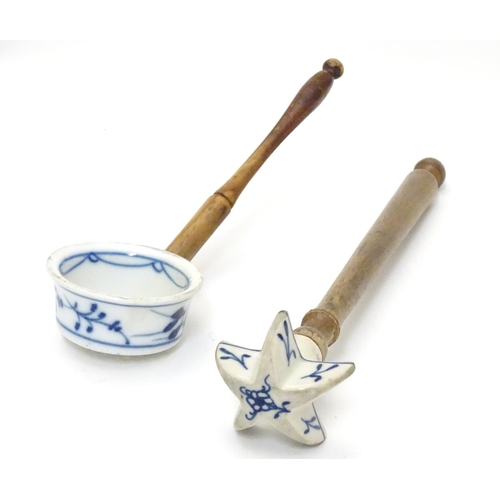 1112 - Kitchenalia : Two Continental cooking utensils with ceramic ends and turned wooden handles, the cera... 