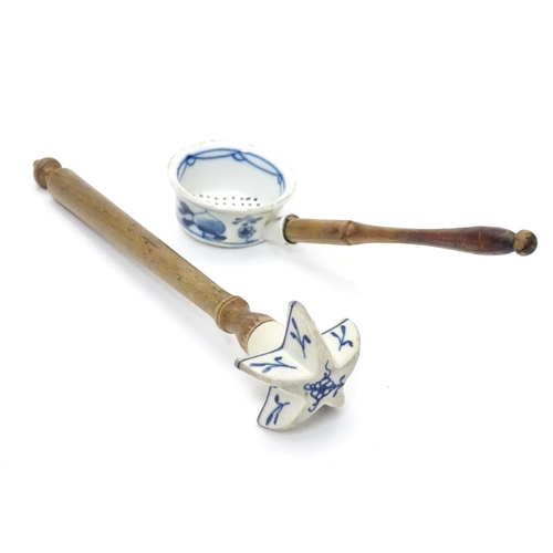 1112 - Kitchenalia : Two Continental cooking utensils with ceramic ends and turned wooden handles, the cera... 