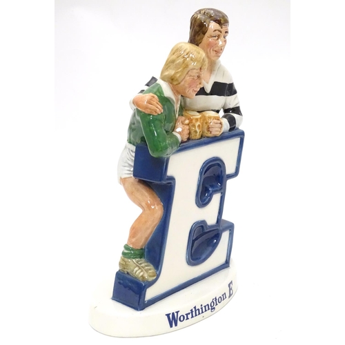 1120 - Brewiana : A Beswick bar top adverting figure group for ' Worthington E ' . Depicting rugby players ... 