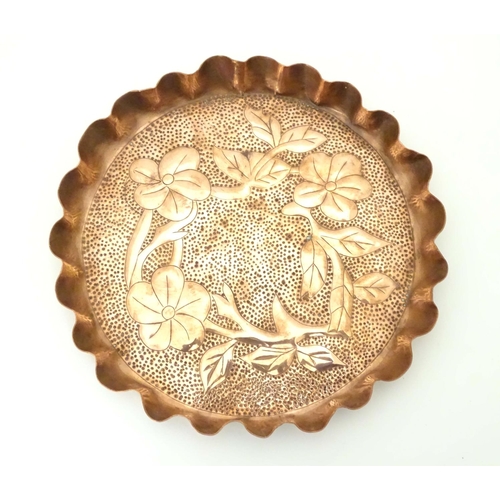 802 - An Arts & Crafts style copper tray with repousse floral decoration and punch detail. Approx. 8