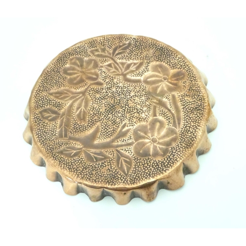 802 - An Arts & Crafts style copper tray with repousse floral decoration and punch detail. Approx. 8