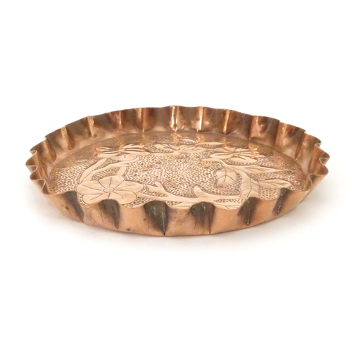 802 - An Arts & Crafts style copper tray with repousse floral decoration and punch detail. Approx. 8