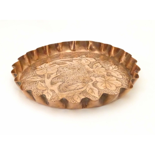 802 - An Arts & Crafts style copper tray with repousse floral decoration and punch detail. Approx. 8