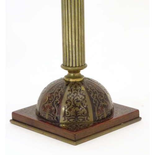 805 - A pair of 19thC Regency brass and tortoiseshell Boulle candlesticks with domed square bases and reed... 