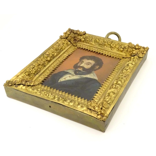 814 - A 19thC oil on board portrait miniature depicting a gentleman wearing a blue jacket, a wide collared... 