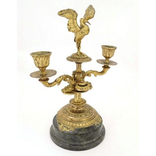 820 - A 19thC ormolu candelabrum on a turned marble base surmounted by a stork bird. Approx. 11 1/4