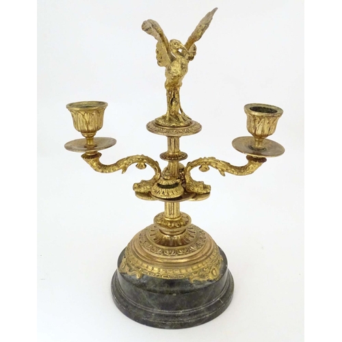 820 - A 19thC ormolu candelabrum on a turned marble base surmounted by a stork bird. Approx. 11 1/4