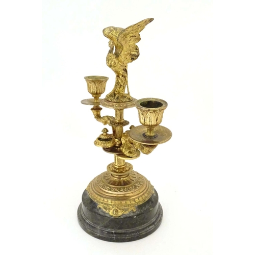 820 - A 19thC ormolu candelabrum on a turned marble base surmounted by a stork bird. Approx. 11 1/4