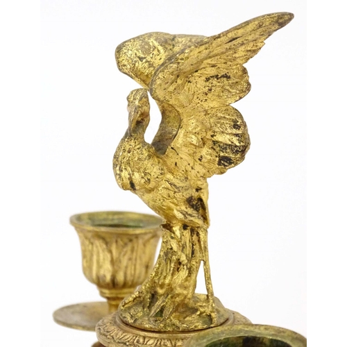 820 - A 19thC ormolu candelabrum on a turned marble base surmounted by a stork bird. Approx. 11 1/4