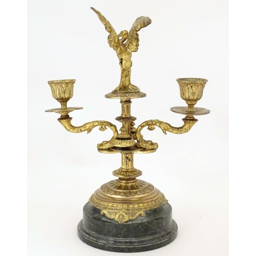 820 - A 19thC ormolu candelabrum on a turned marble base surmounted by a stork bird. Approx. 11 1/4