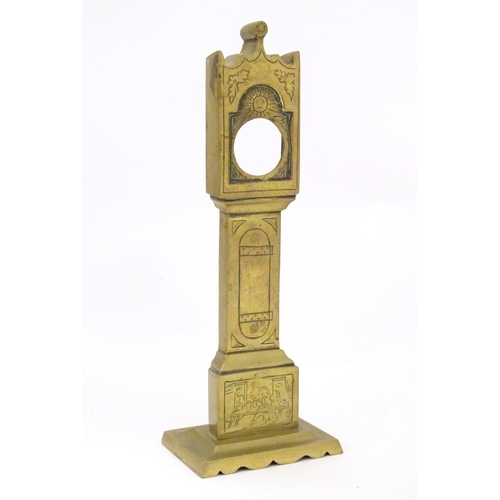 829 - A late 19th / early 20thC brass pocket watch holder modelled as a miniature long case clock with nai... 