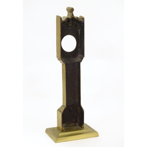 829 - A late 19th / early 20thC brass pocket watch holder modelled as a miniature long case clock with nai... 