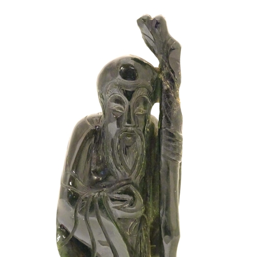 841 - A Chinese carved hardstone jade sage figure, possibly Shou-Hing, the Chinese god of longevity as a b... 