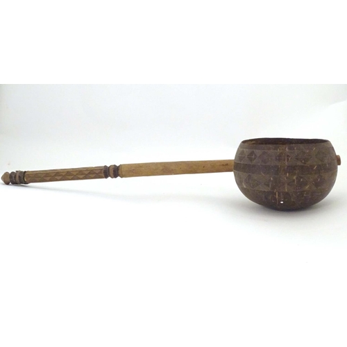 935 - Ethnographic / Native / Tribal: A late 19th / early 20thC ladle with a carved handle incised with cr... 