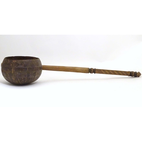 935 - Ethnographic / Native / Tribal: A late 19th / early 20thC ladle with a carved handle incised with cr... 