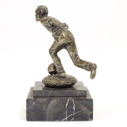 947 - A 20thC cast figure modelled as a man bowling, on a stepped marble base. Approx. 5 1/4