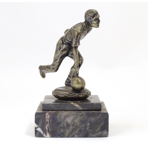 947 - A 20thC cast figure modelled as a man bowling, on a stepped marble base. Approx. 5 1/4