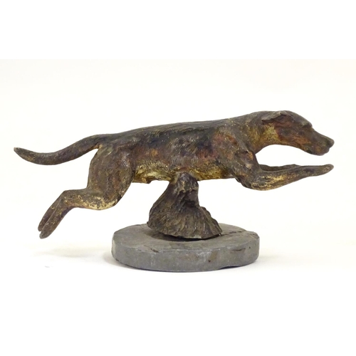 953 - A late 19th / early 20thC cold painted bronze car mascot modelled as a running hound / dog, on an as... 